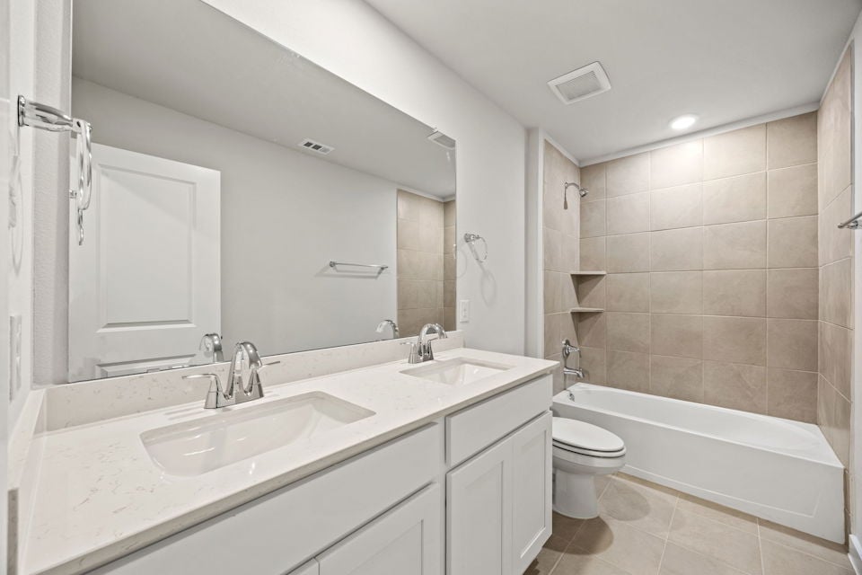 A bathroom with a tub sink and toilet.