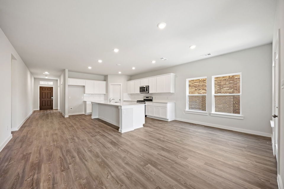 A large kitchen with white cabinets.