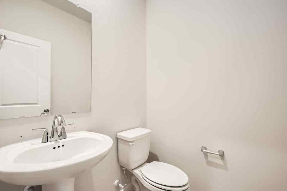 A bathroom with a toilet and sink.