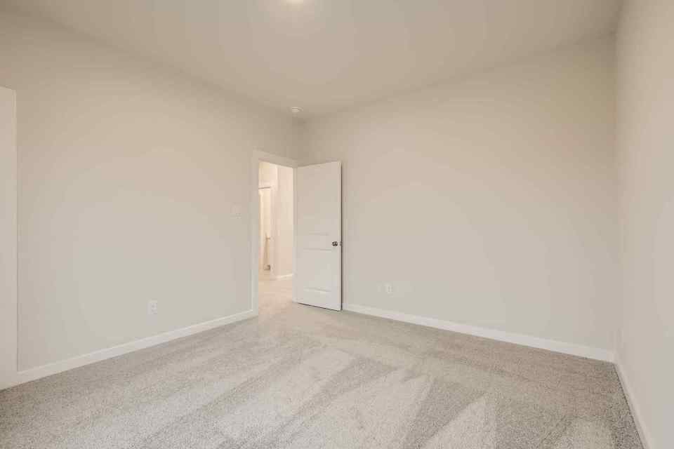 A hallway with white walls.