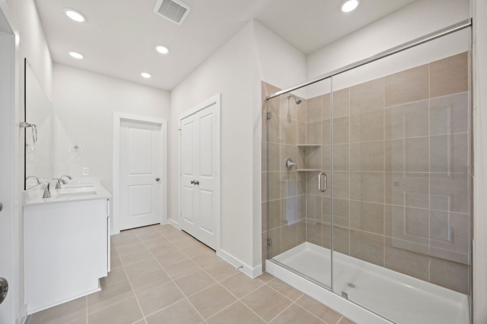 A bathroom with a glass shower.