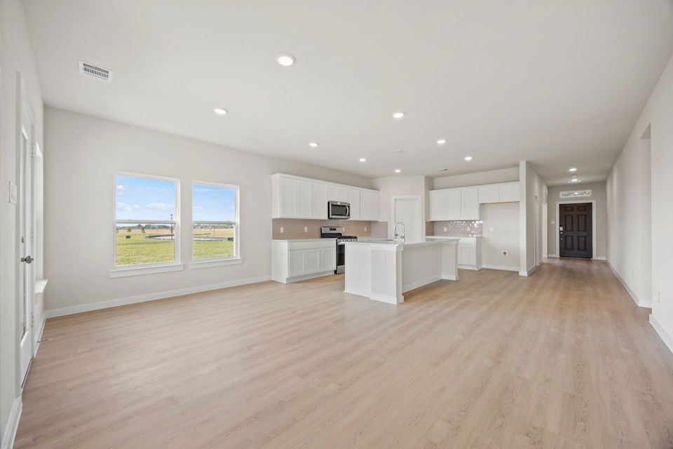 A large kitchen with white cabinets.