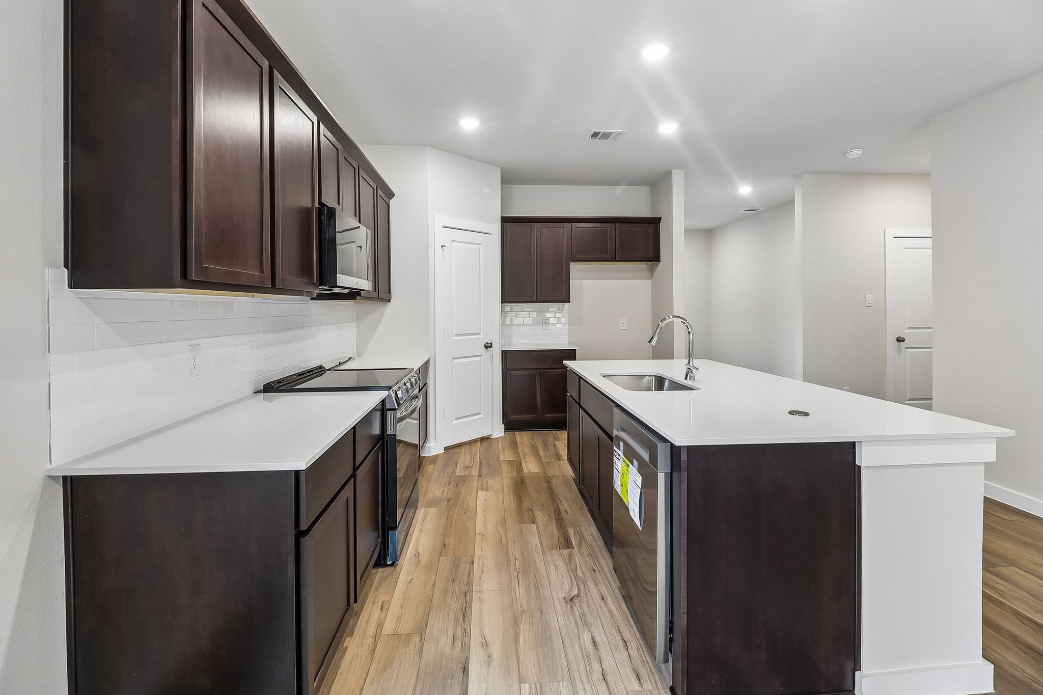 A kitchen with black cabinets.