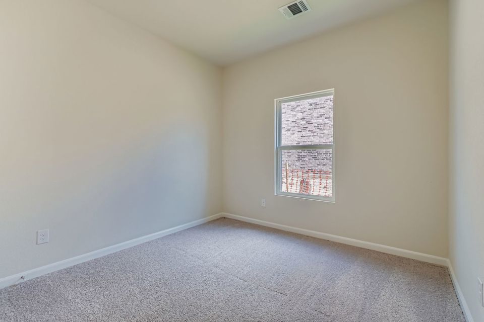 A room with a window and carpet.