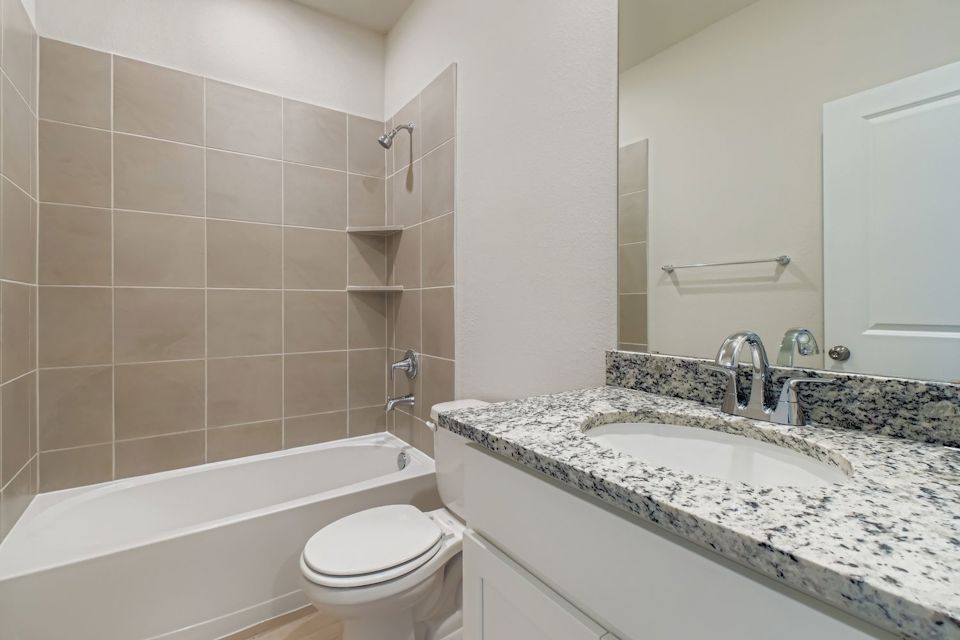 A bathroom with a marble countertop.