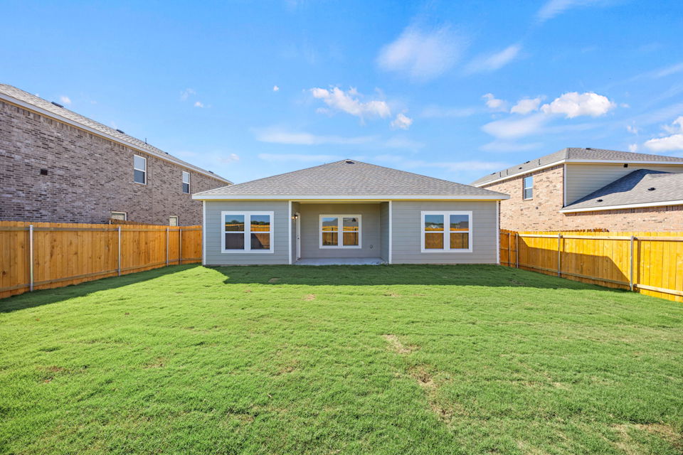 A house with a fence and grass.