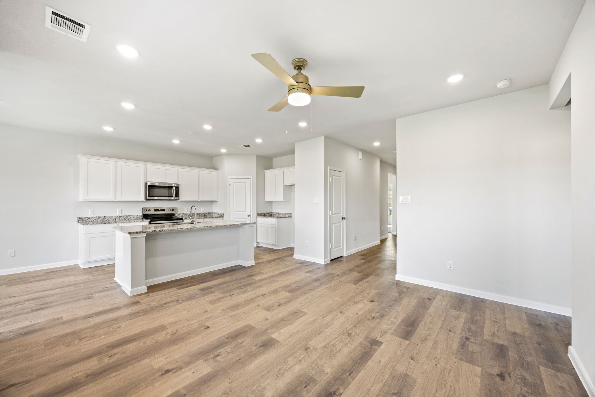 A kitchen with white cabinets.