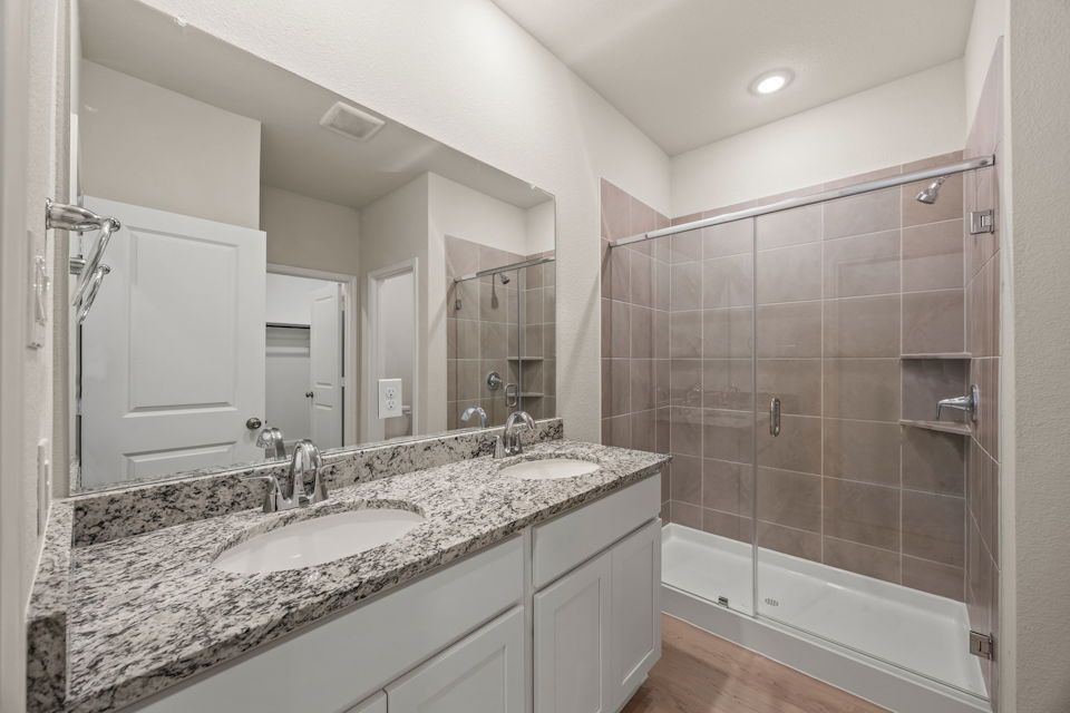 A bathroom with a large mirror.
