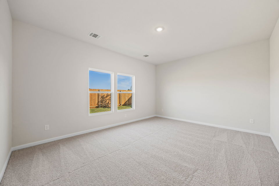 A room with a window and a carpet.