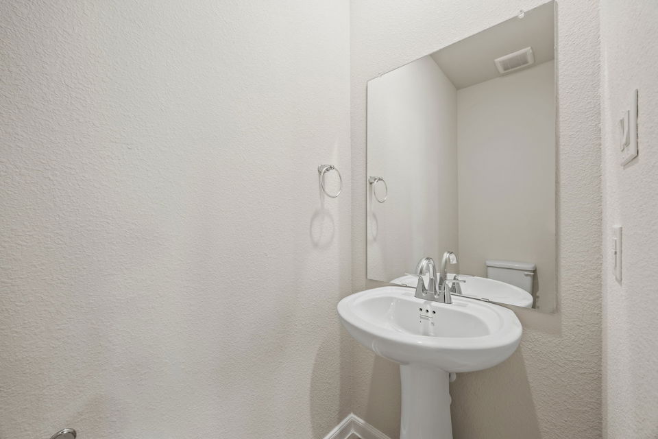 A bathroom with a sink and mirror.