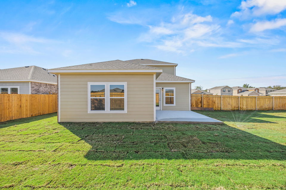 A house with a fence and grass.