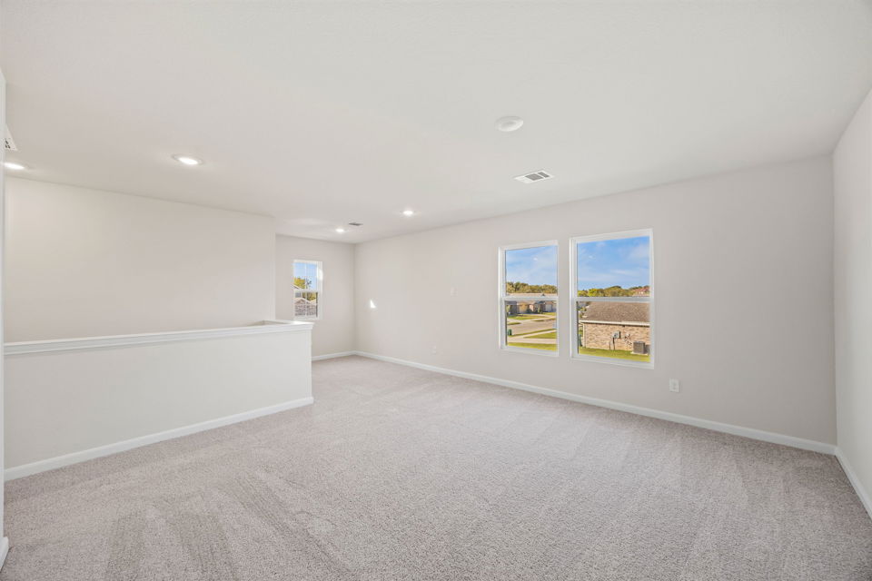 A room with a few paintings on the wall.