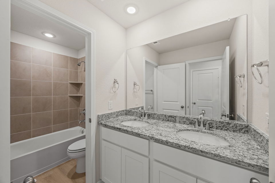 A bathroom with a marble countertop.