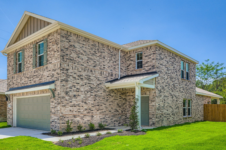 A stone building with a garage.