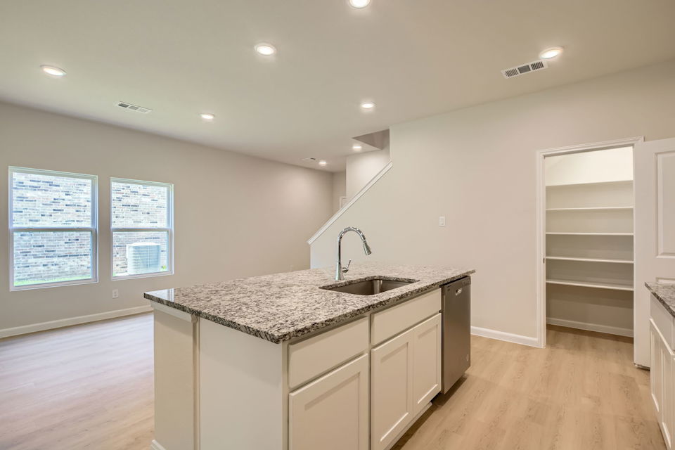 A kitchen with a marble countertop.