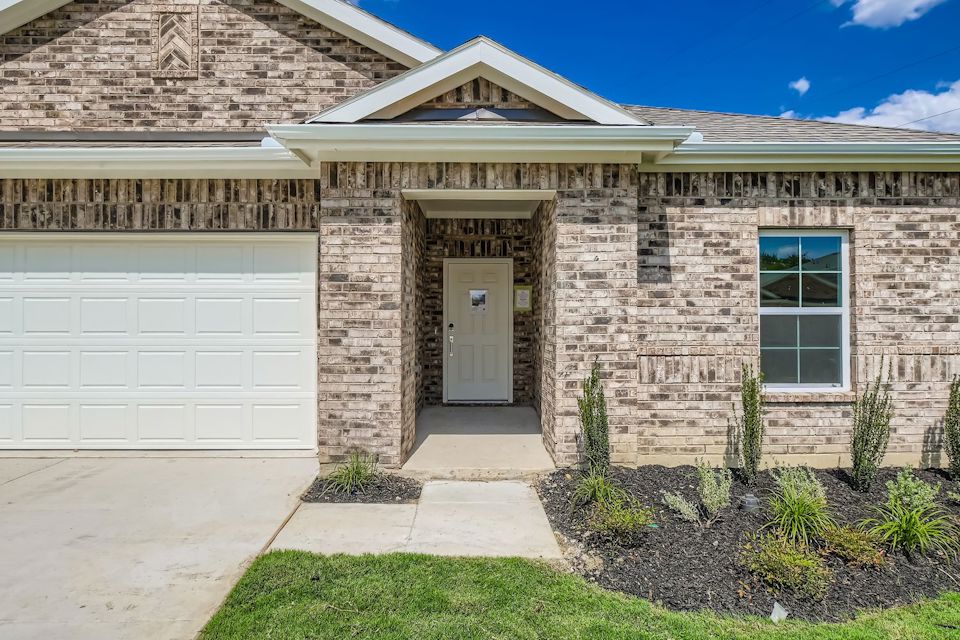 A house with a garage and a door.