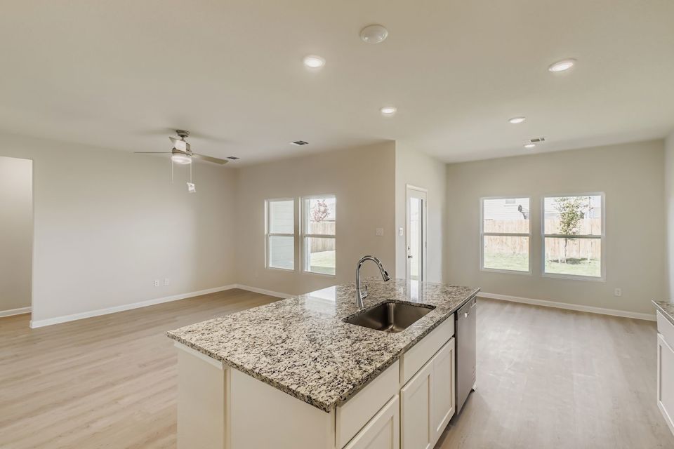 A kitchen with marble counters.