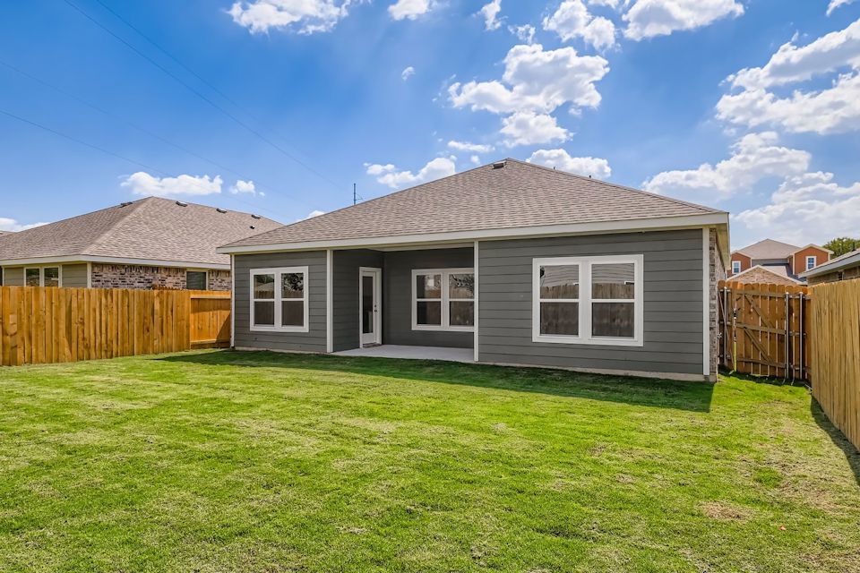 A house with a fence and grass.