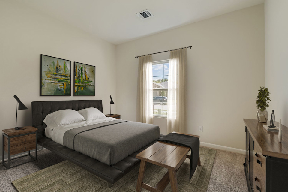 A bedroom with a bed and a coffee table.
