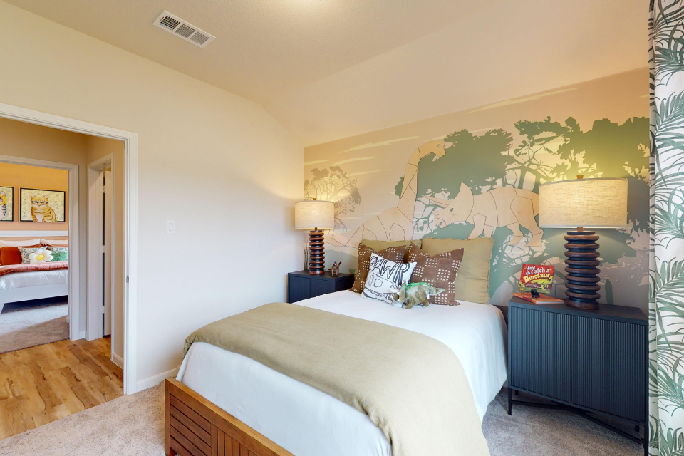 A bedroom with a bed and lamps.