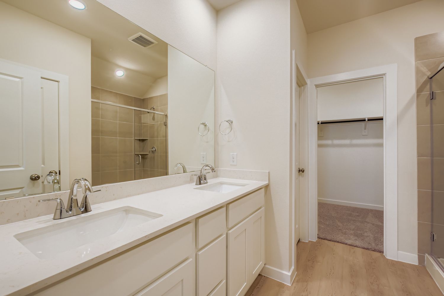 A bathroom with a large mirror.
