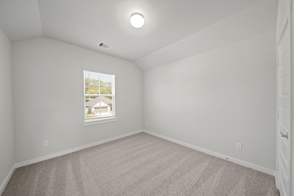 A room with a window and a carpet.