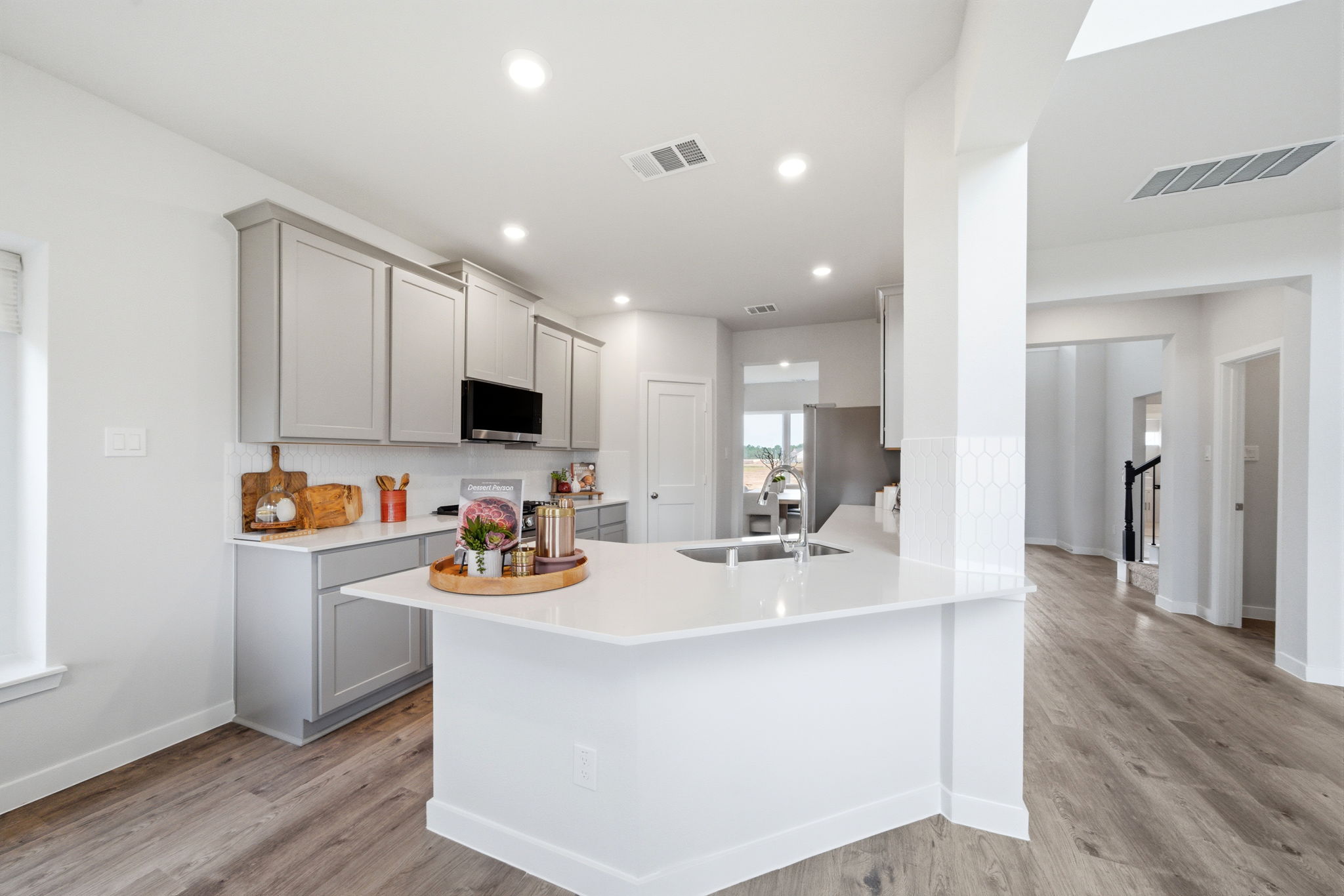 A kitchen with white cabinets.