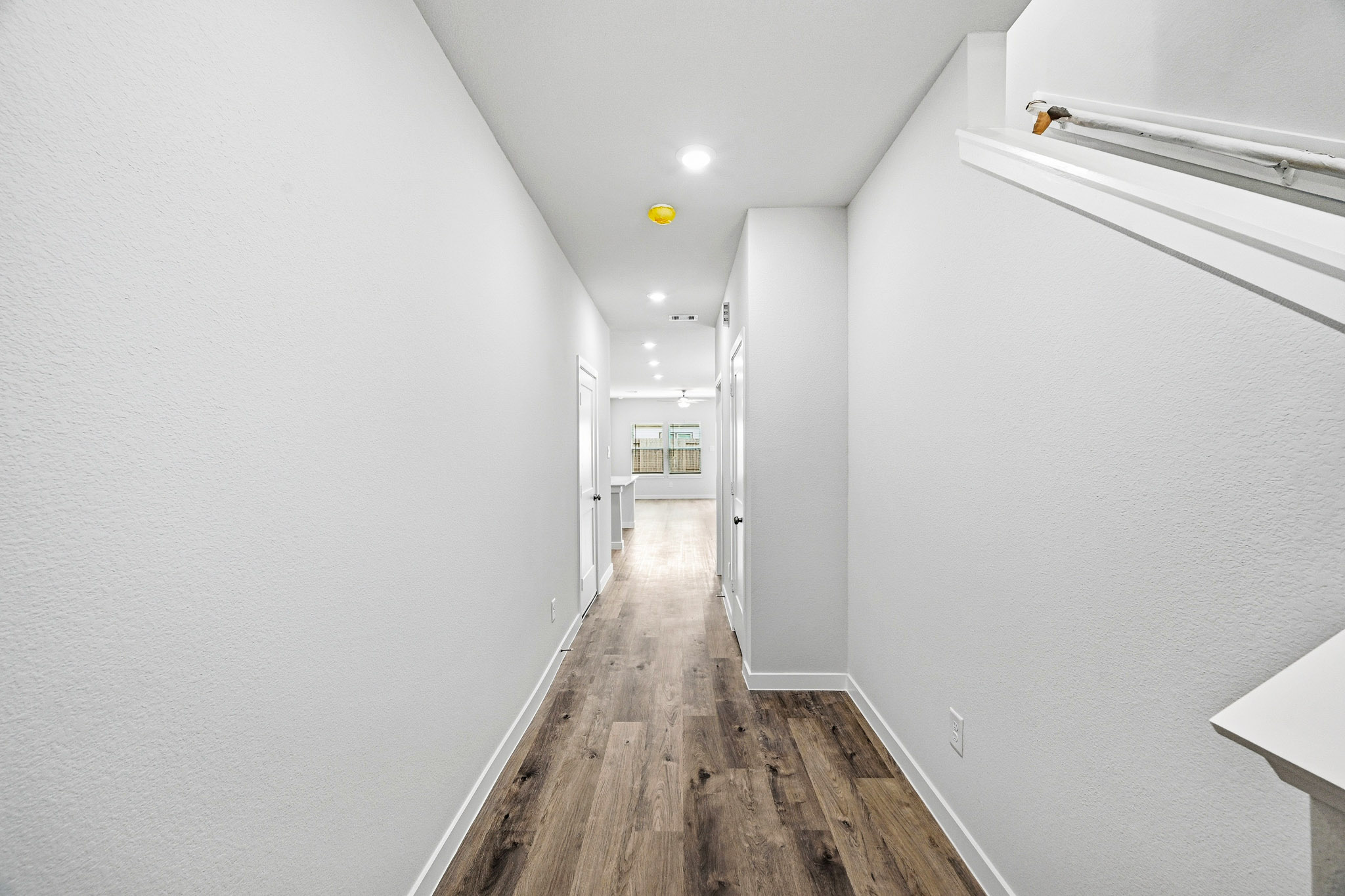 A hallway with white walls.