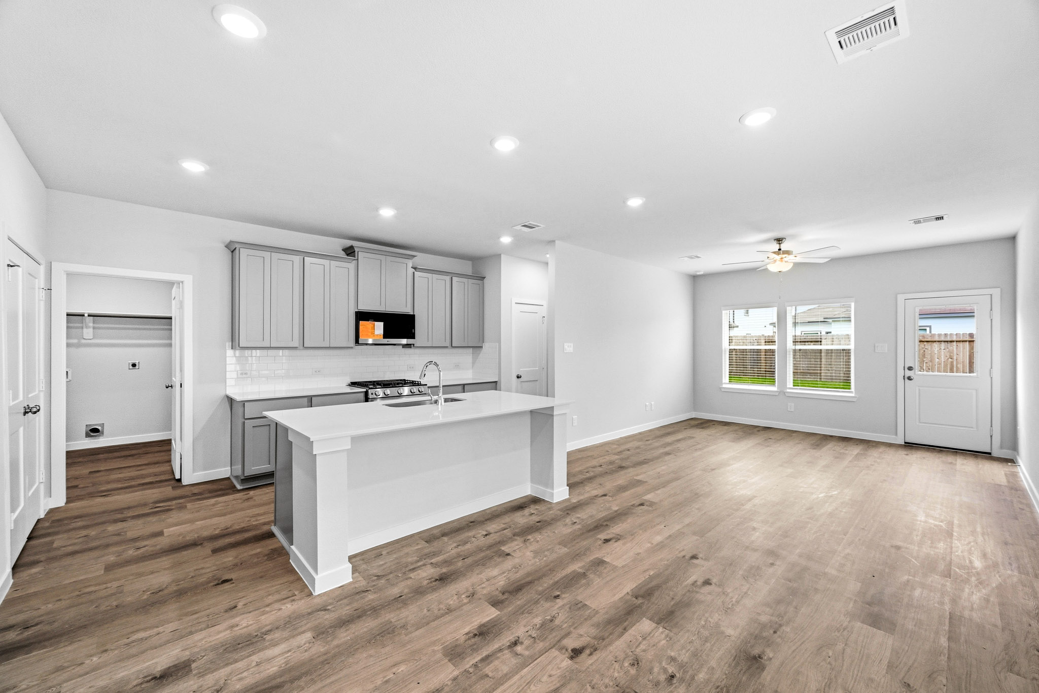 A kitchen with white cabinets.