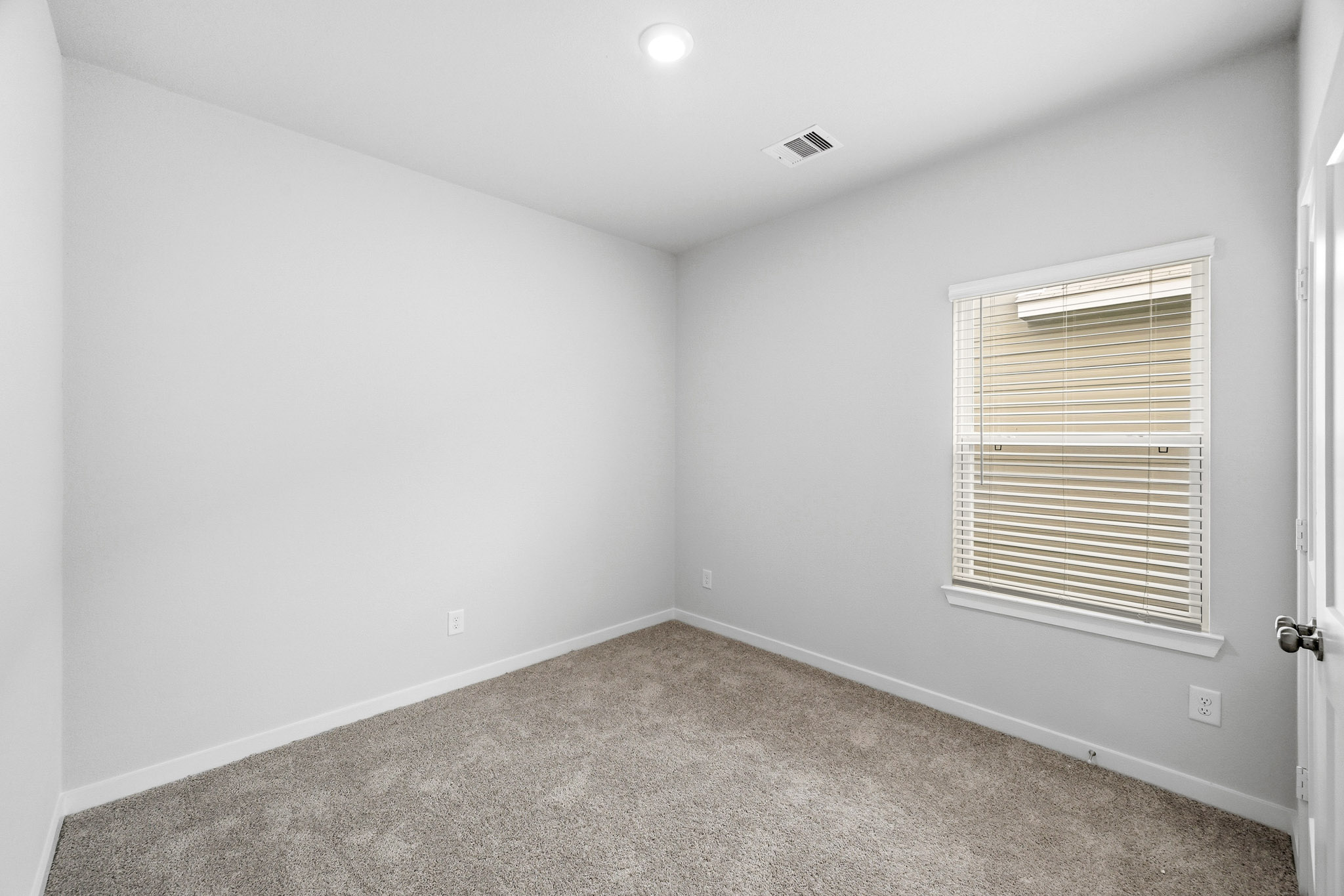 A room with a door and a window.