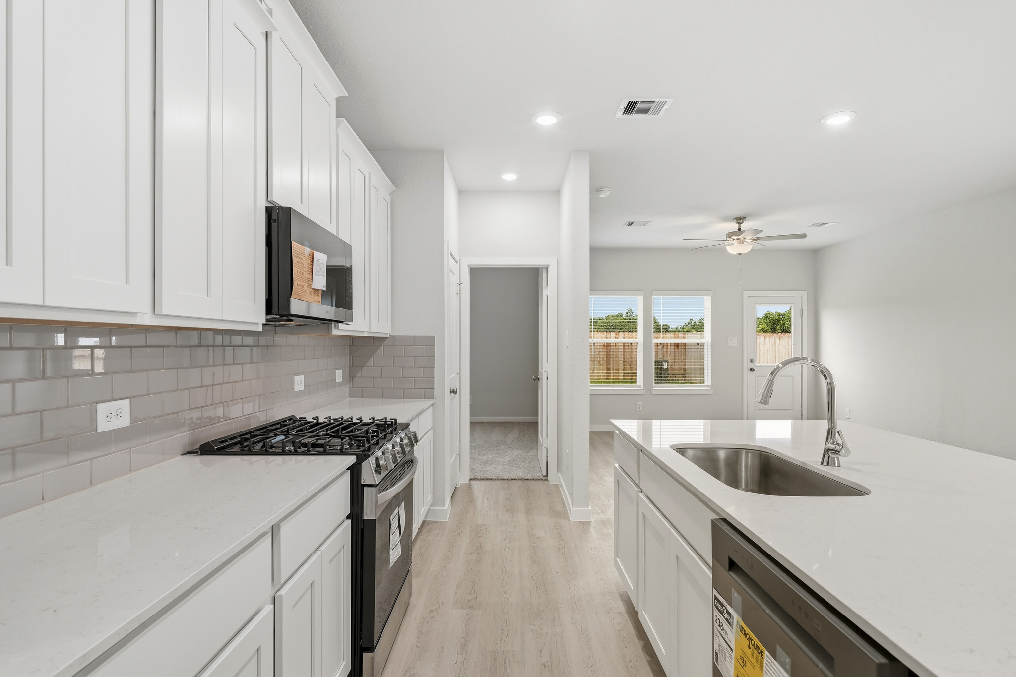 A kitchen with white cabinets.