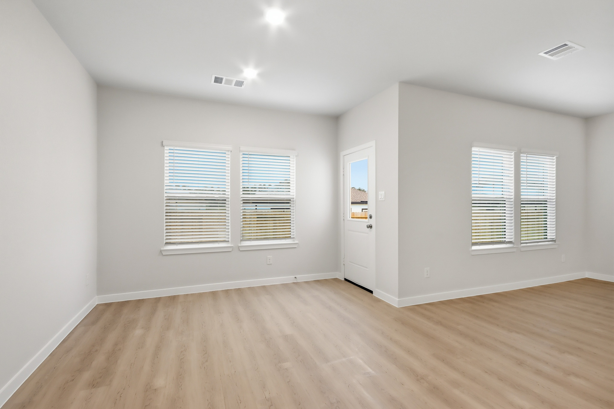 A room with a wood floor and white walls.