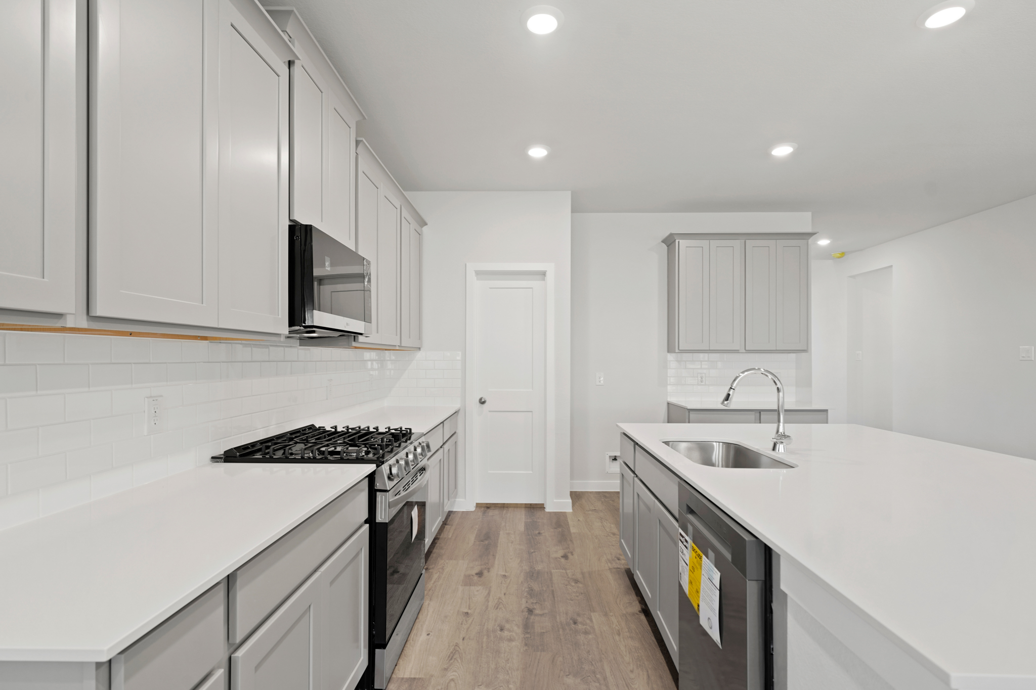 A kitchen with white cabinets.