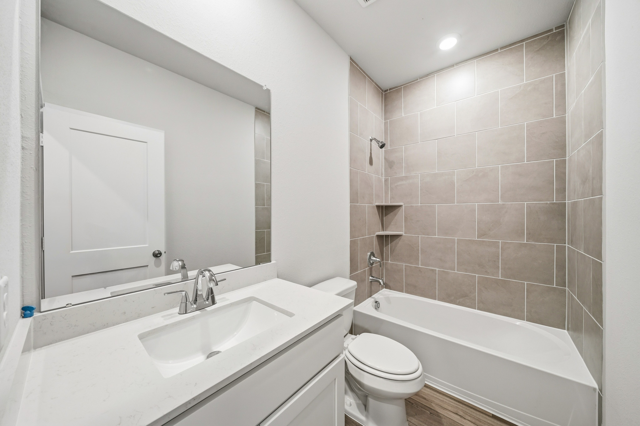 A bathroom with a tub sink and toilet.