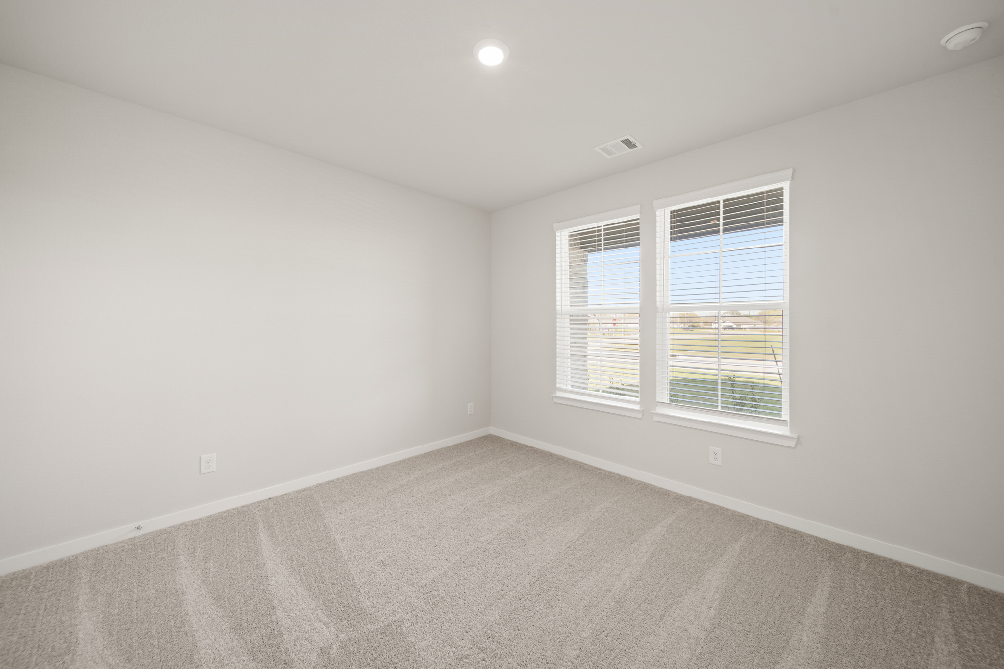 A room with a window and a carpet.