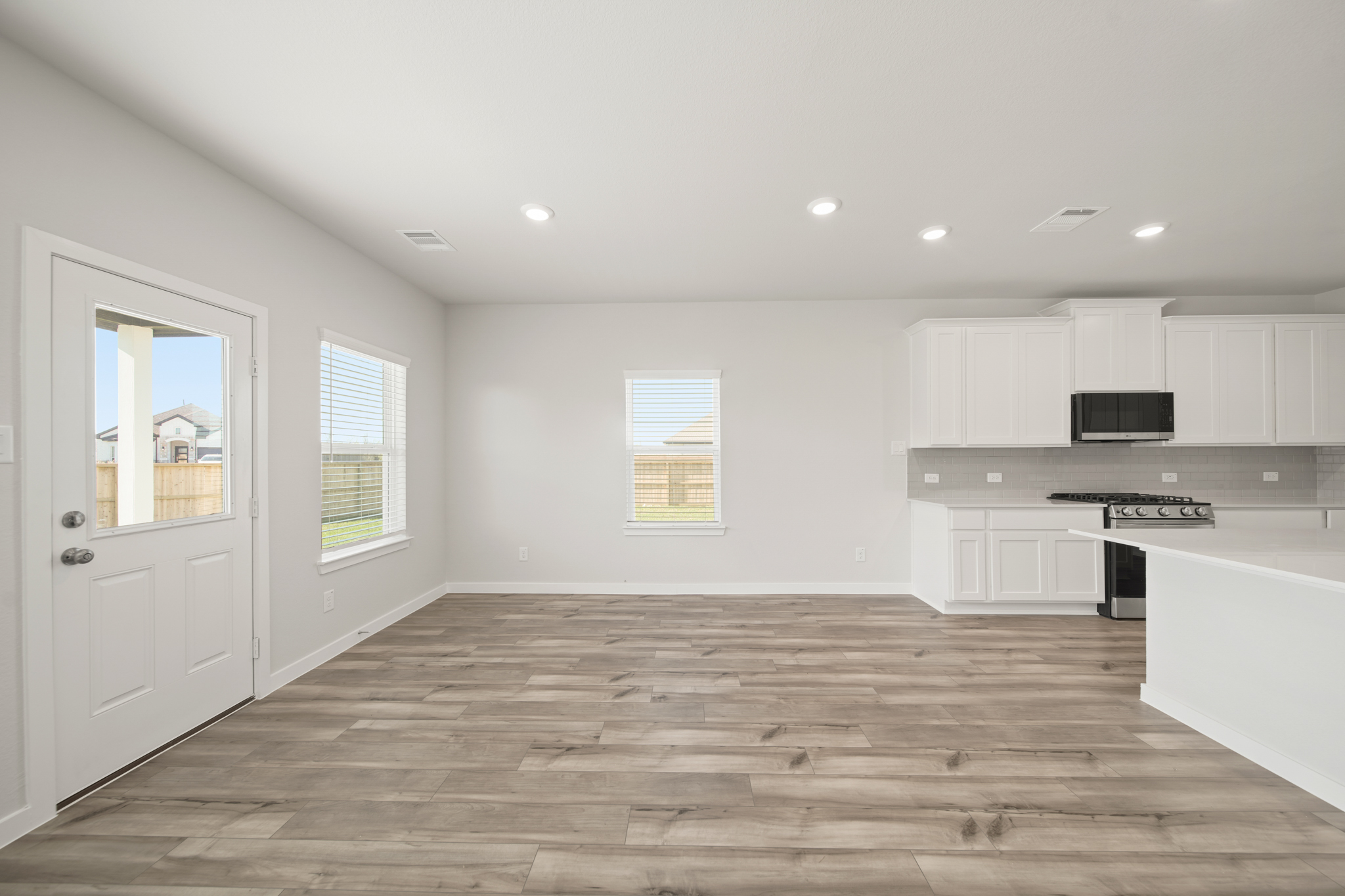 A kitchen with white cabinets.