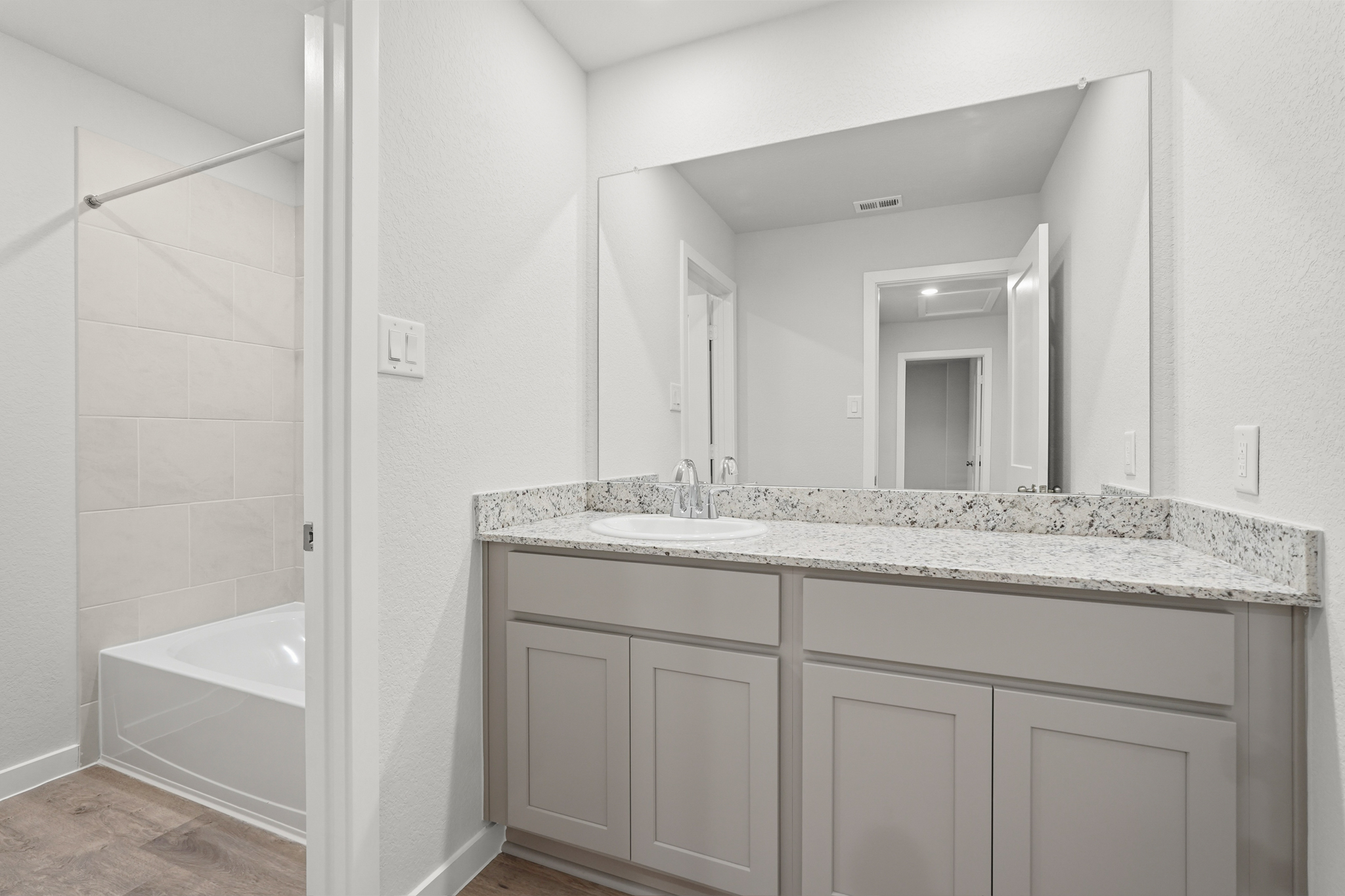 A bathroom with a marble countertop.