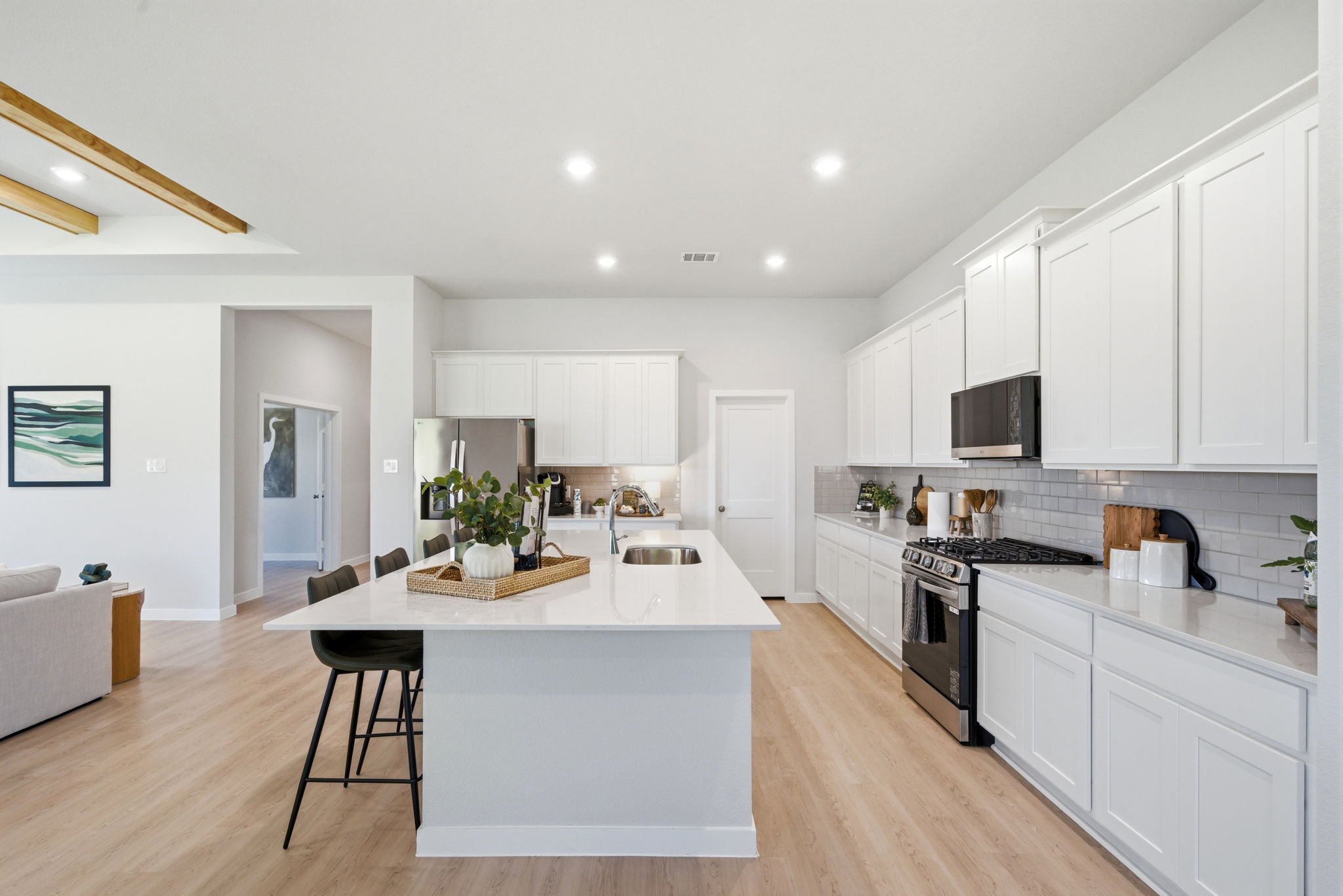 A kitchen with white cabinets.