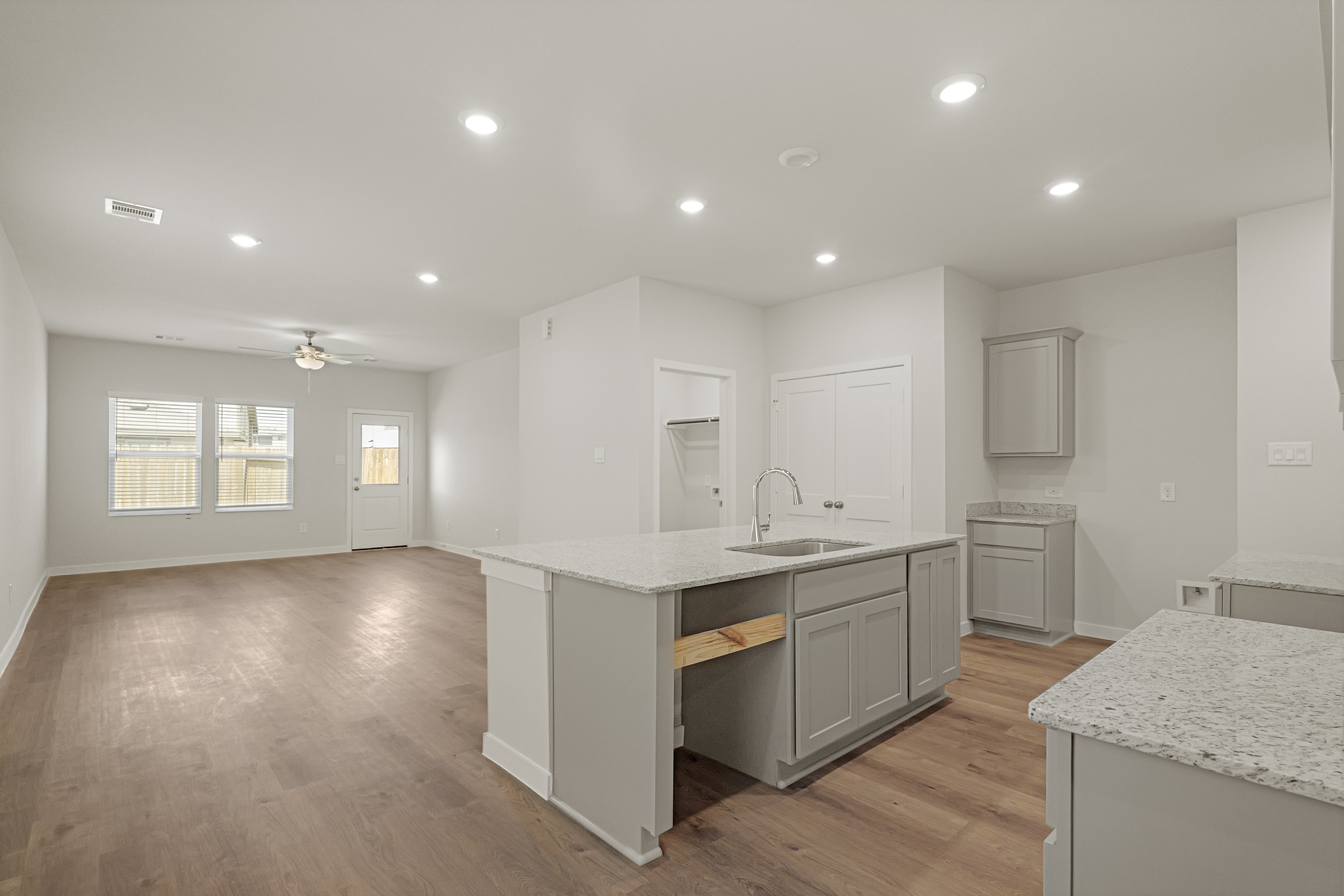A kitchen with white cabinets.