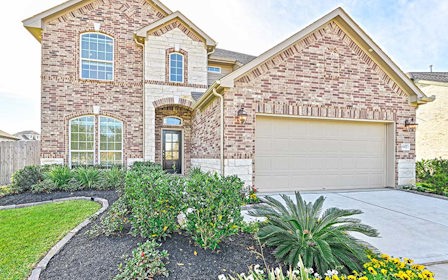 A brick house with a garage.