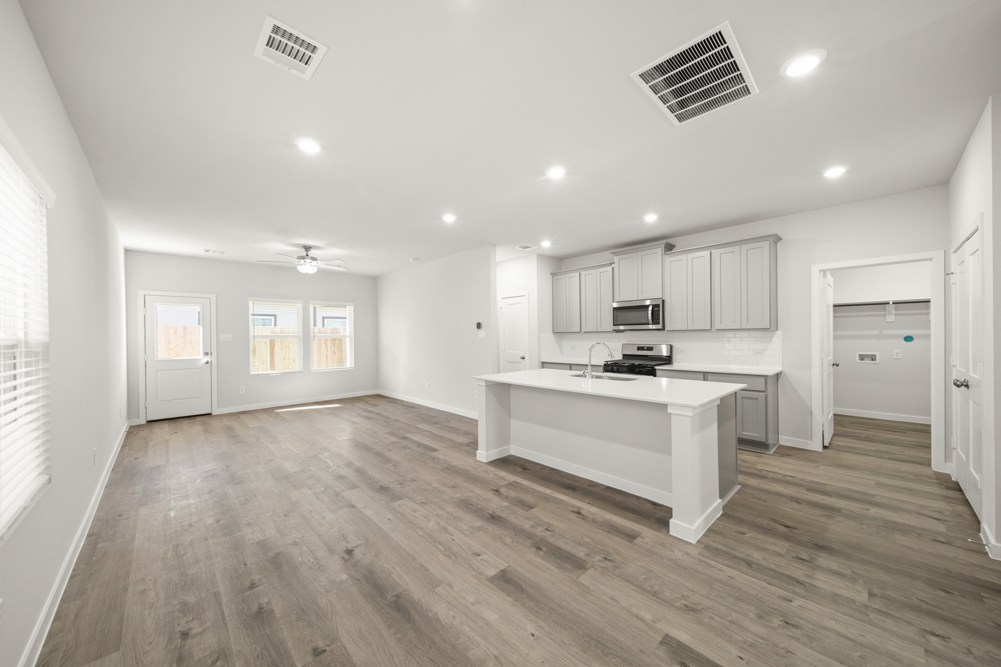 A large kitchen with white cabinets.