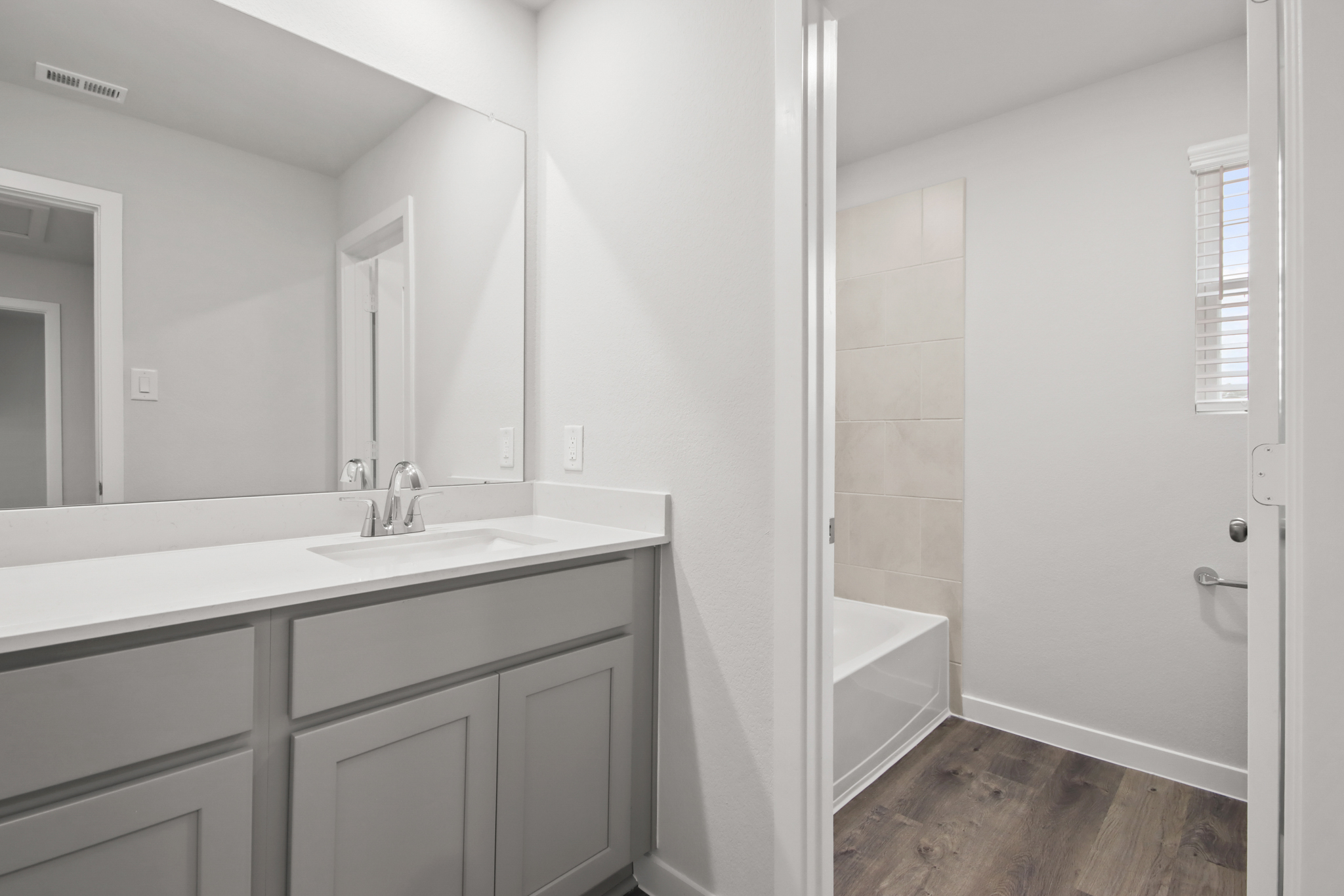 A bathroom with a sink and a bathtub.