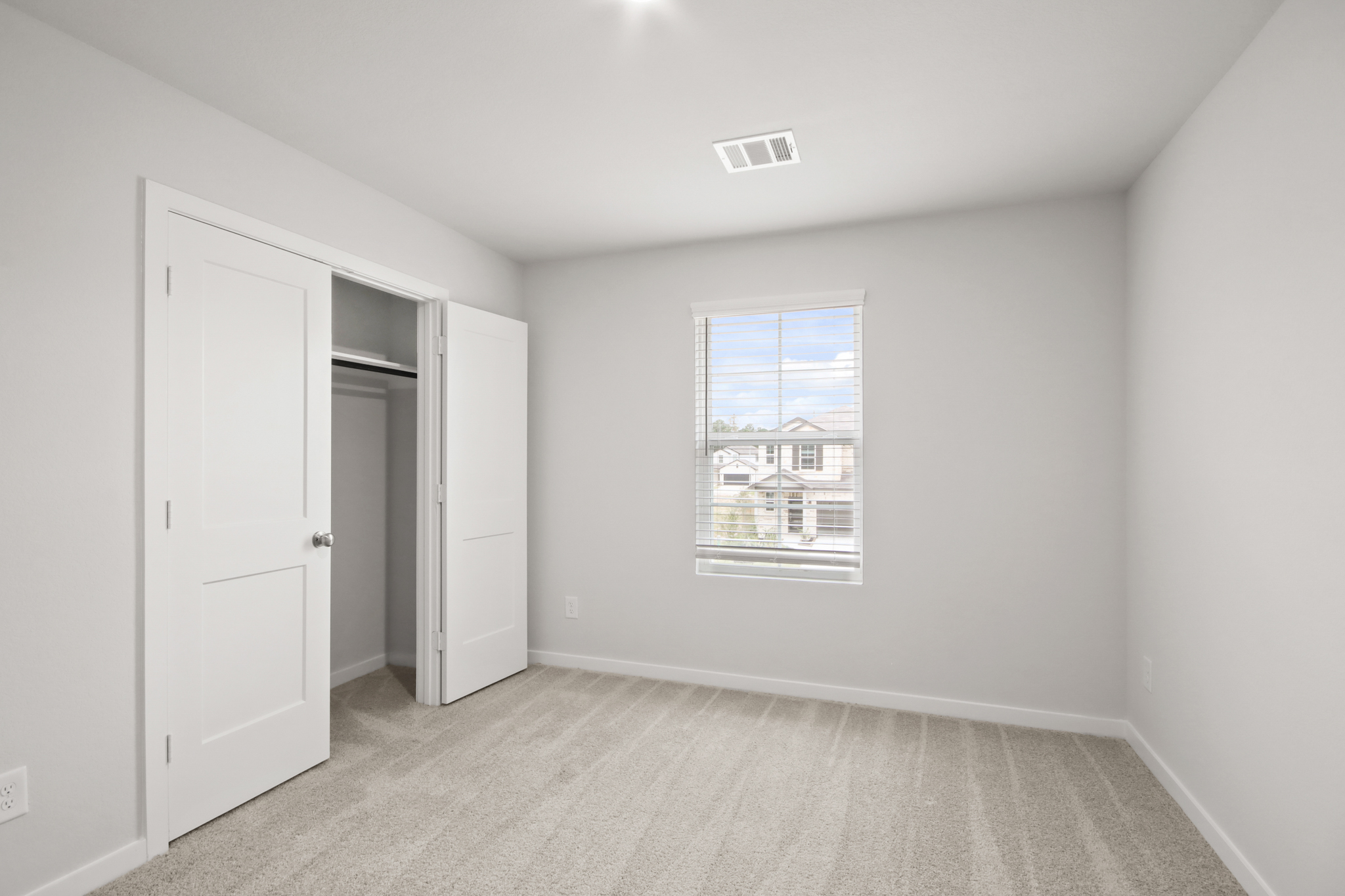 A room with white walls and a window.