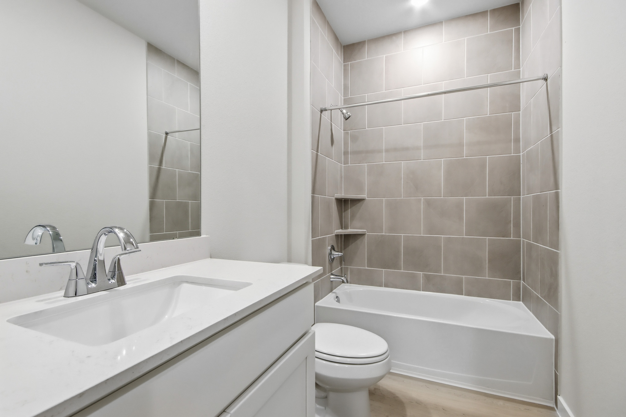 A bathroom with a tub sink and toilet.