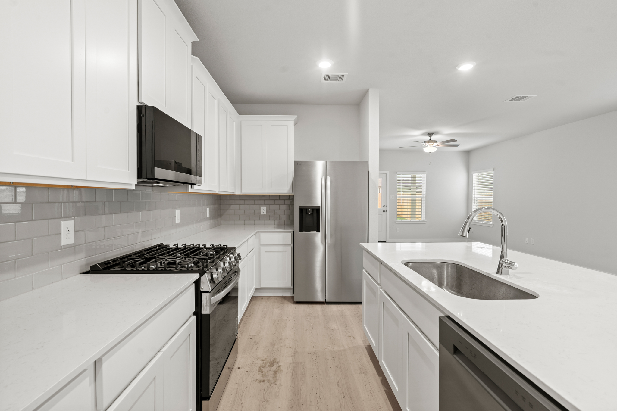 A kitchen with white cabinets.