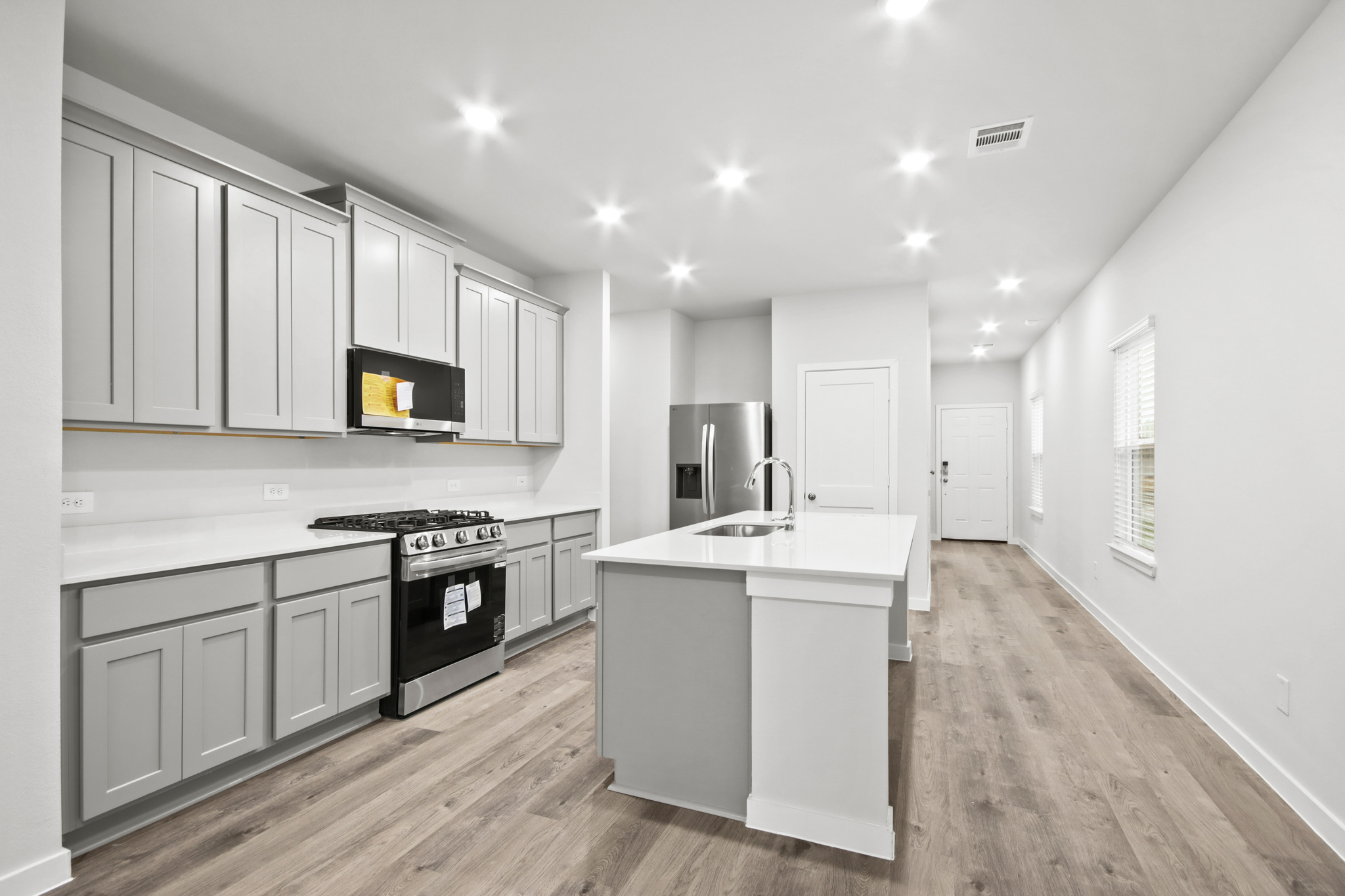 A kitchen with white cabinets.