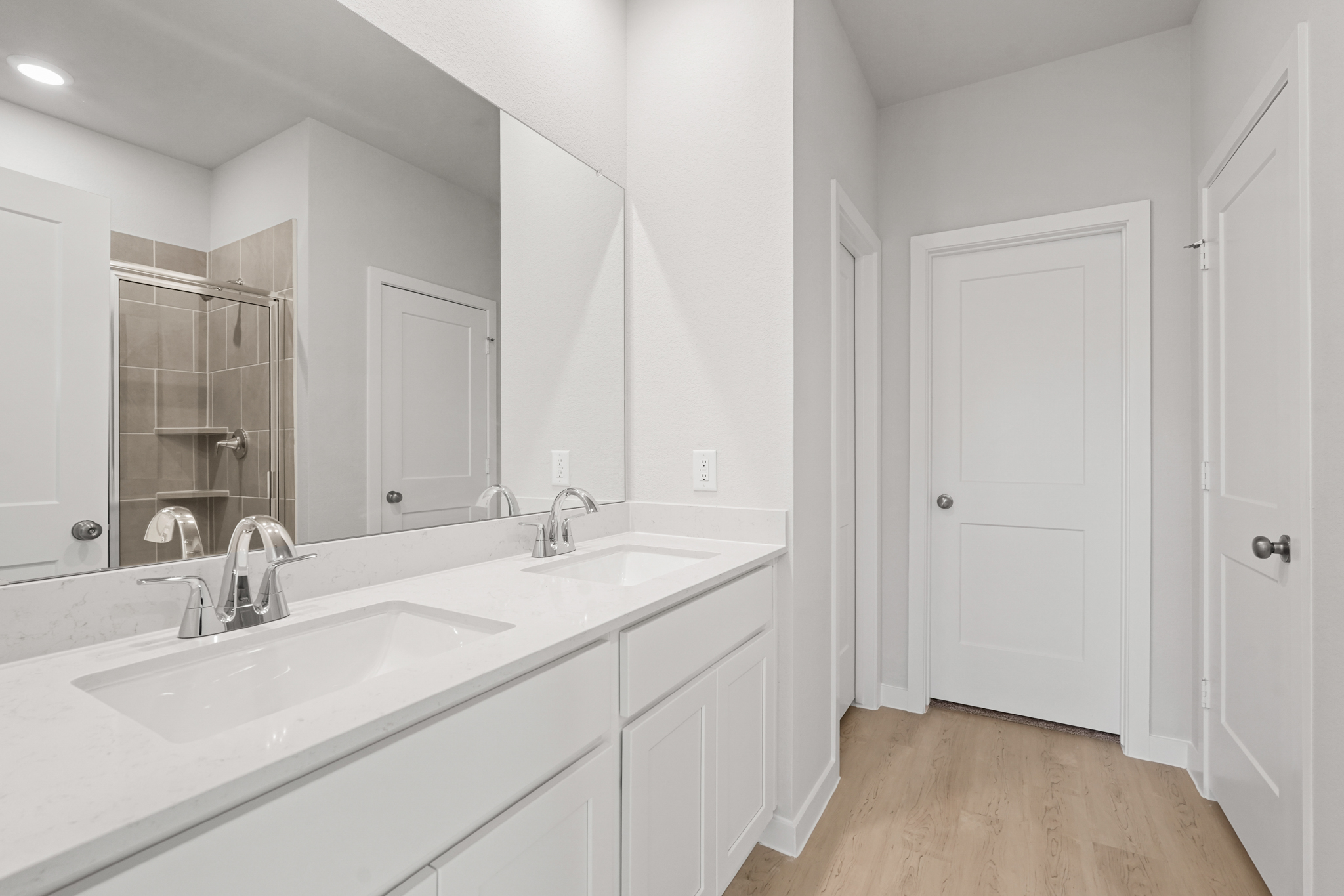 A bathroom with a large mirror.