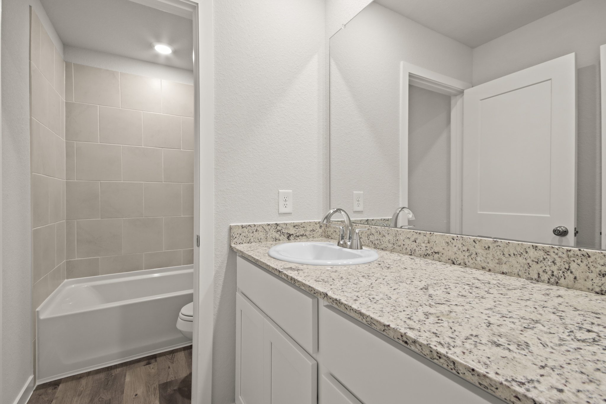 A bathroom with a marble countertop.