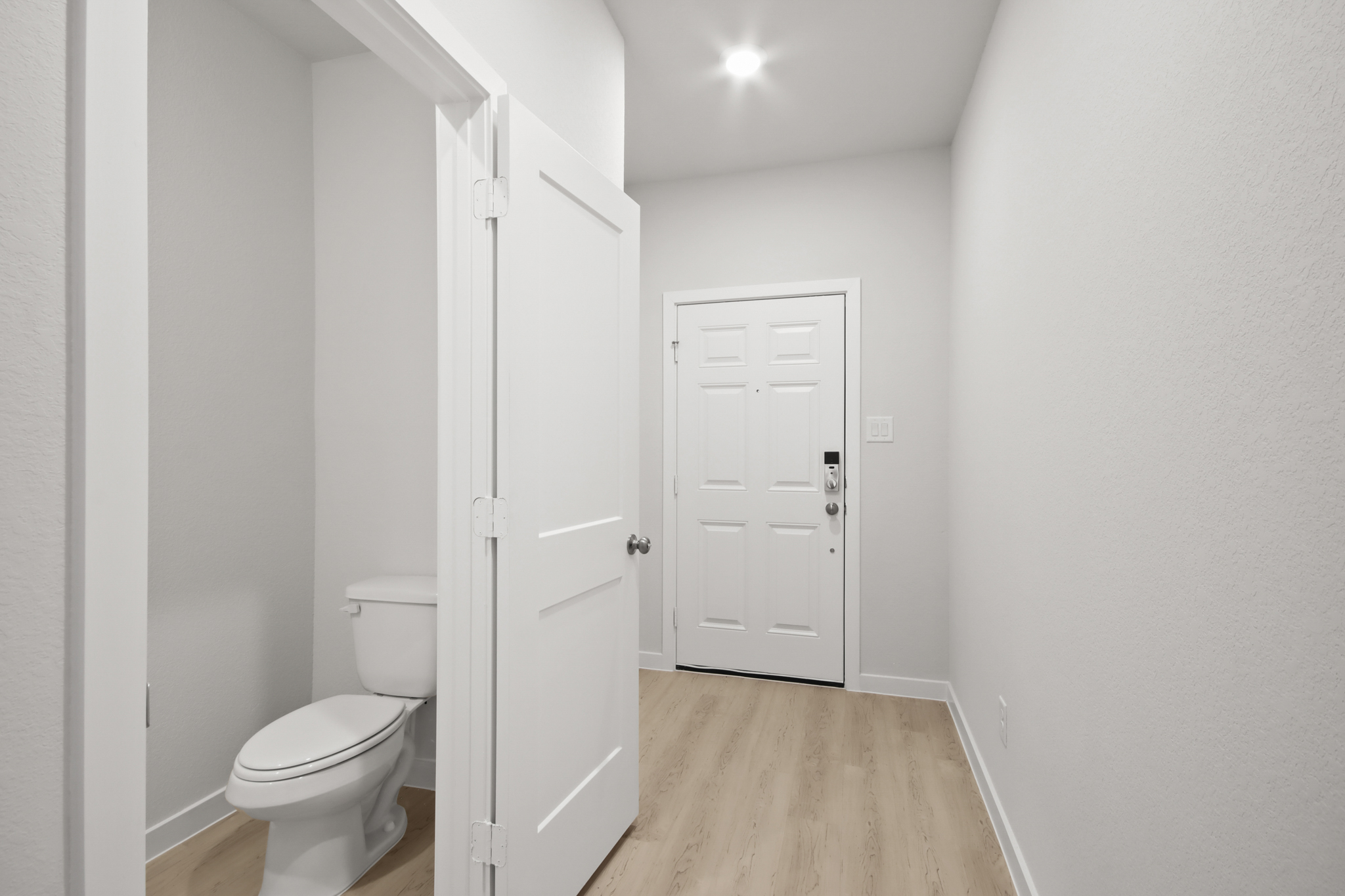 A bathroom with white doors.