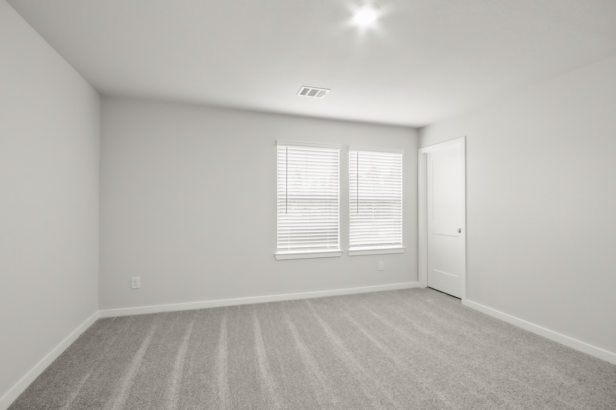 A room with a door and windows.